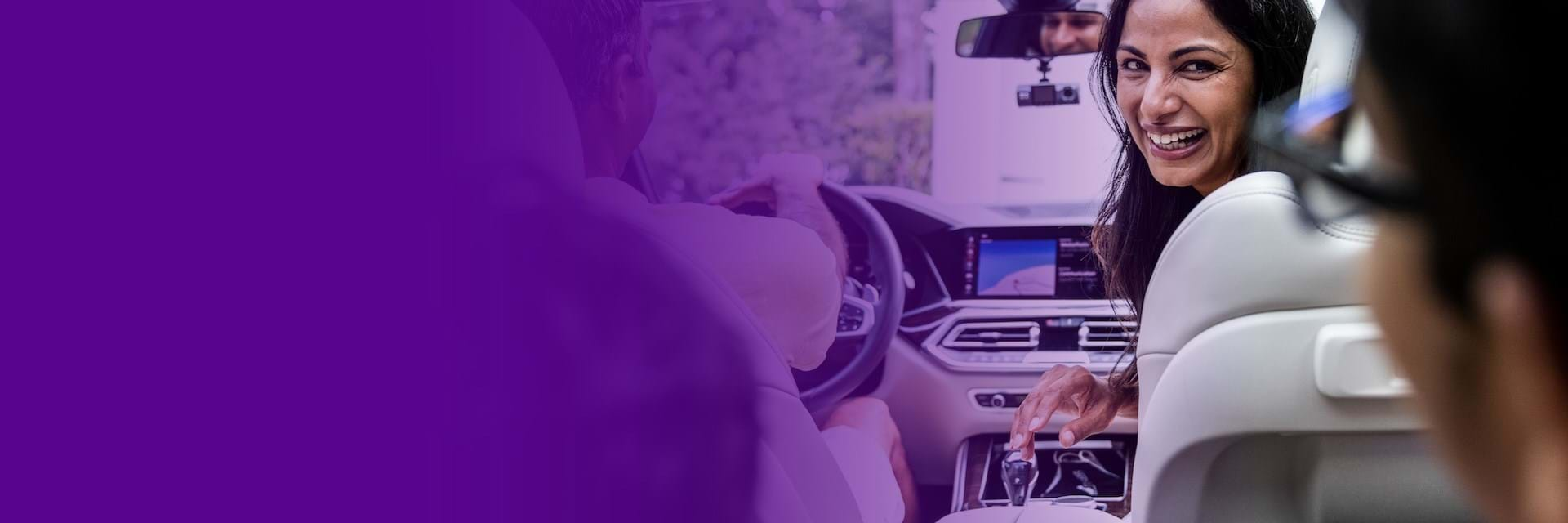 Smiling woman in passenger seat in car