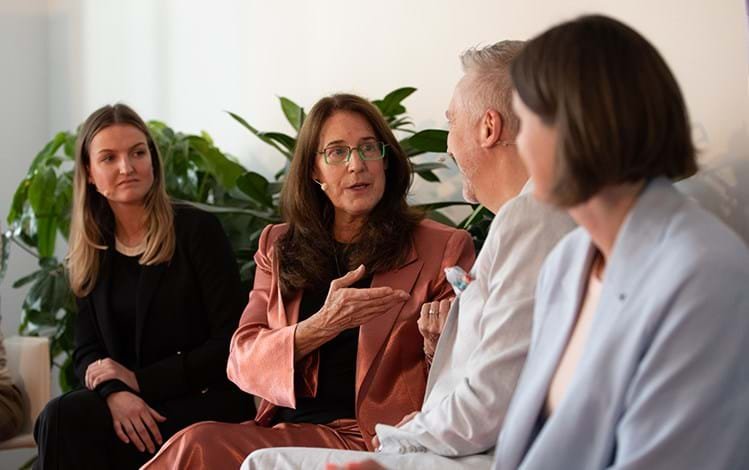 Woman in a pink business suite presenting in the office