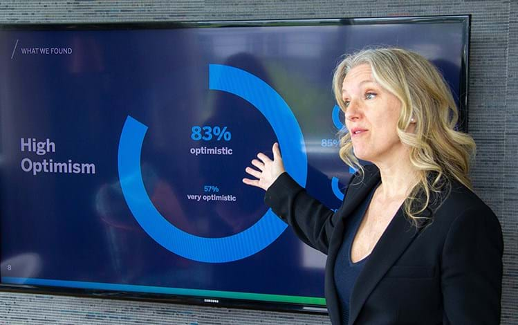 Two women brainstorming with sticky notes on a board